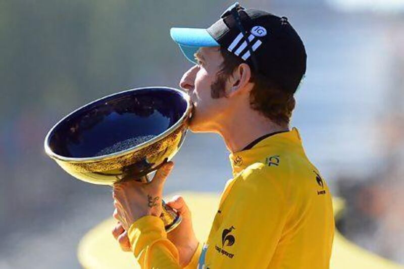 Bradley Wiggins, winner of the 2012 Tour de France cycling race kisses the trophy on the podium of the the Tour de France cycling race in Paris on uly 22, 2012. AP Photo / Jerome Prevost