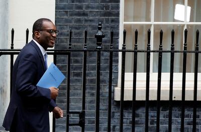 Kwasi Kwarteng carries his growth plan in Downing Street. Reuters