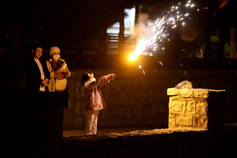 A child holds up a flare, during Charshanbeh Suri celebrations in Tehran, Iran. AFP