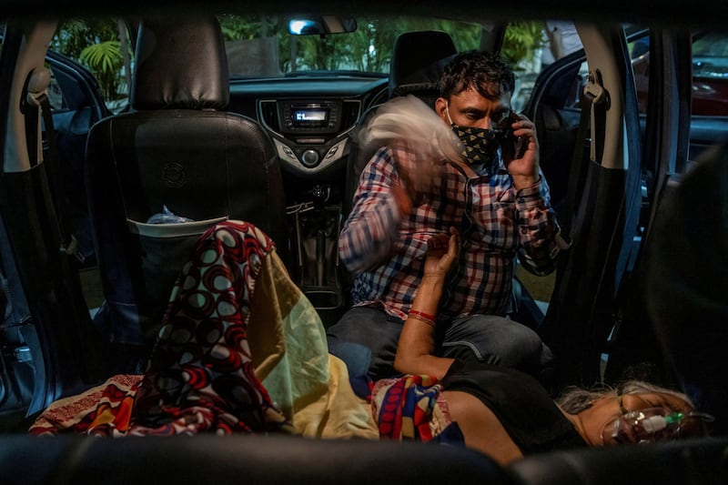 Siddiqui takes a picture of Manoj Kumar as his mother Vidhya Devi receives oxygen in the parking lot of a Sikh temple during the Covid-19 pandemic in Ghaziabad, India, on April 24, 2021. Reuters