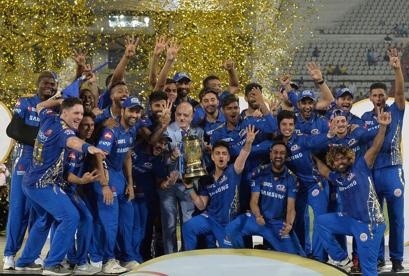 Mumbai Indians team players celebrate with the trophy after their victory against Chennai Super Kings in the 2019 Indian Premier League (IPL) Twenty20 final cricket match at the Rajiv Gandhi International Cricket Stadium in Hyderabad on May 13, 2019. (Photo by NOAH SEELAM / AFP) / ----IMAGE RESTRICTED TO EDITORIAL USE - STRICTLY NO COMMERCIAL USE-----