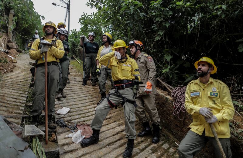 Firefighters observe as a person is rescued in Petropolis. EPA