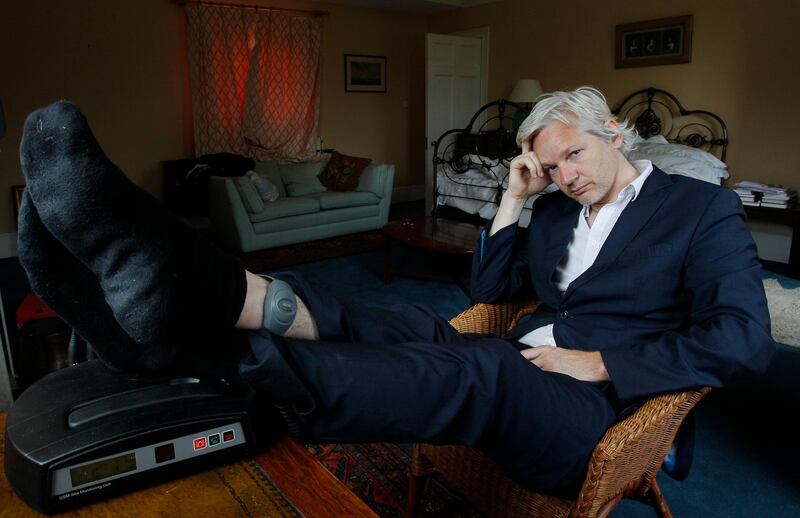 FILE - In this Wednesday, June 15, 2011 file photo, WikiLeaks founder Julian Assange is seen with his ankle security tag at the house where he is required to stay, near Bungay, England. Police in London arrested WikiLeaks founder Assange at the Ecuadorean embassy Thursday, April 11, 2019 for failing to surrender to the court in 2012, shortly after the South American nation revoked his asylum. (AP Photo/Kirsty Wigglesworth, file)