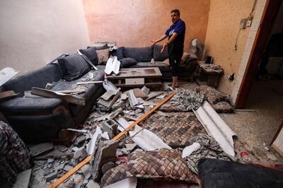 A man inspects a house damaged by a nearby Israeli air strike at the Jabalia camp for Palestinian refugees in the northern Gaza Strip on August 6, 2022.  AFP