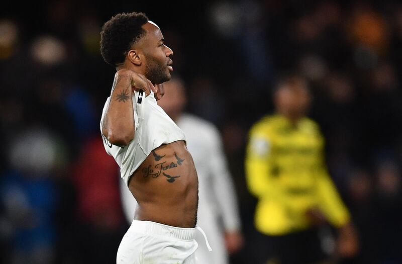 Manchester City's Raheem Sterling raises his top to reveal his tattoos after the final whistle. EPA