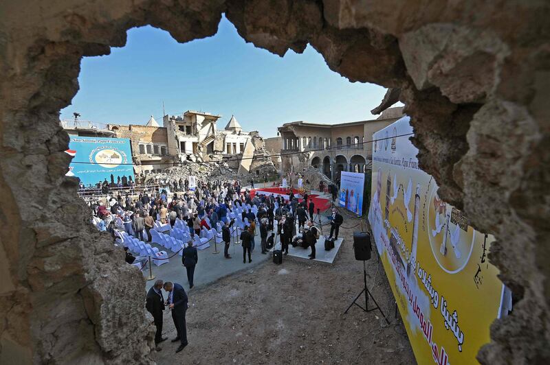 Iraqis gather in the ruins of the Syriac Catholic Church of the Immaculate Conception (al-Tahira-l-Kubra), in the northern city of Mosul, amidst preparations ahead of the Pope's visit, on March 7, 2021.  Pope Francis, on his historic Iraq tour, visits today Christian communities that endured the brutality of the Islamic State group until the jihadists' "caliphate" was defeated three years ago / AFP / Vincenzo PINTO                
