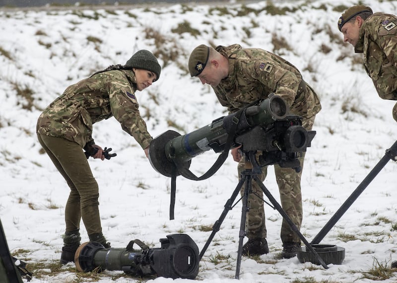 The Princess of Wales is shown a weapon system used by the Irish Guards. PA