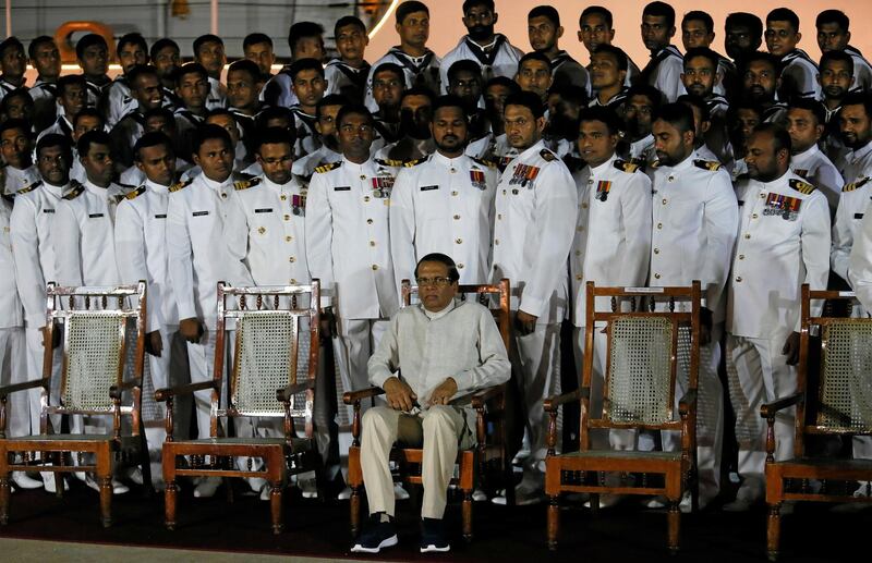 FILE PHOTO: Sri Lanka's President Maithripala Sirisena waits next to Navy officers for a group photo during a commissioning handover ceremony of the P 626 ship by U.S. at the main port in Colombo, Sri Lanka June 6, 2019. REUTERS/Dinuka Liyanawatte/File Photo