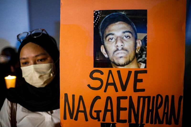 An activist protests at a candlelit vigil against the execution of  Malaysian citizen Nagaenthran Dharmalingam, who was convicted of a drug offence 11 years ago in Singapore but had been diagnosed as intellectually disabled, outside Singapore's embassy in Kuala Lumpur. EPA 