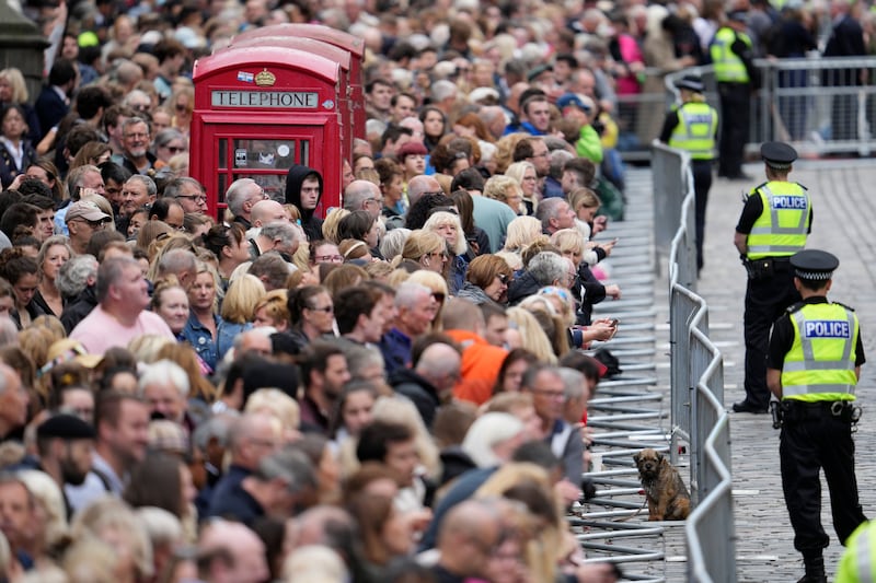 Crowds gather to watch the procession in Edinburgh. AP
