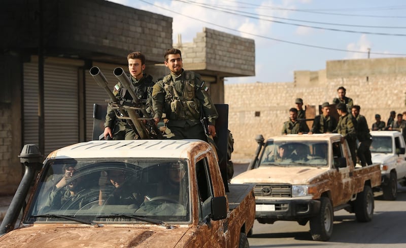 Turkish-backed Syrian rebel fighters gather near the Syrian-Turkish border north of Aleppo. AFP