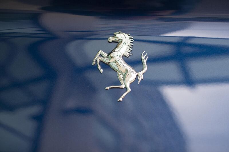 A 'Prancing Horse' badge sits on a Ferrari NV Portofino luxury automobile parked outside the Fiat Chrysler Automobiles NV annual general meeting in Amsterdam, Netherlands, on Friday, April 13, 2018. Sergio Marchionne is set to start his final year as chief executive officer after Fiat Chryslers annual shareholders meeting on Friday in Amsterdam. Photographer: Jasper Juinen/Bloomberg