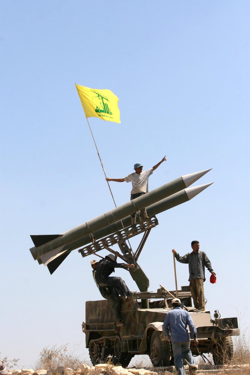 ** FILE ** Hezbollah supporters fix the party's flag on top of their rocket models in Bourj Qalawi near the southern port city of Tyre, Lebanon in this Tuesday, July 10, 2007, file photo. When 30,000 U.N. troops and Lebanese army soldiers were deployed across southern Lebanon at the end of last year's Israel-Hezbollah war, Hezbollah's presence shrank in the villages and hills facing the Israeli border and its influence seemed likely to diminish as well. (AP Photo/Mohammed Zaatari, File)