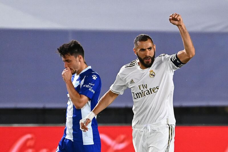 Karim Benzema celebrates next to Alaves' Spanish defender Ximo Navarro after scoring from the penalty spot. AFP