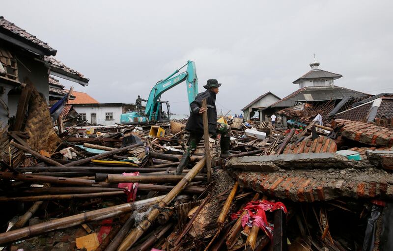 A soldier searches for victims in Sumur. AP Photo