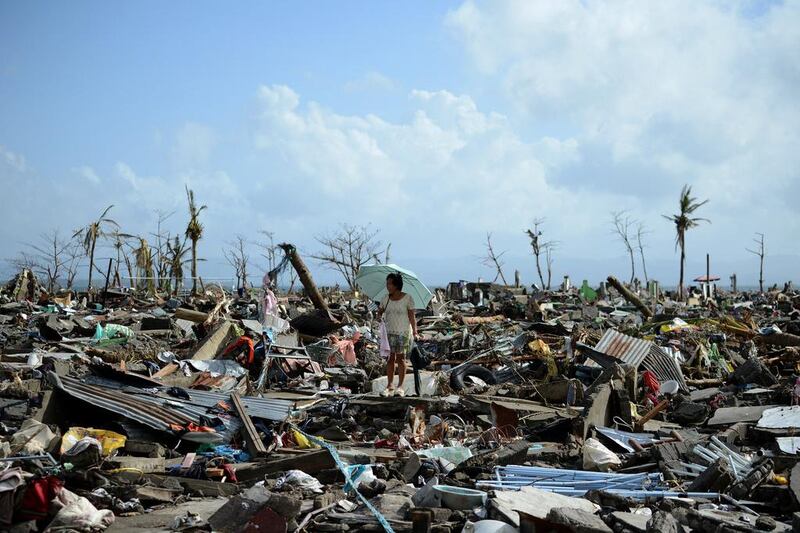 A survivor walks among the debris of houses destroyed by typhoon Haiyan in Tacloban, the Philippines. Noel Celis / AFP




