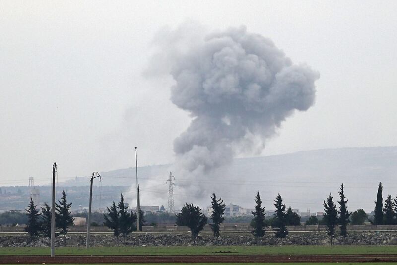 A picture taken from the town of Sarmin in northwestern Syria shows smoke billowing over the village of Qaminas, about 6 kilometres southeast of Idlib city, following reported Syrian air strikes.  AFP