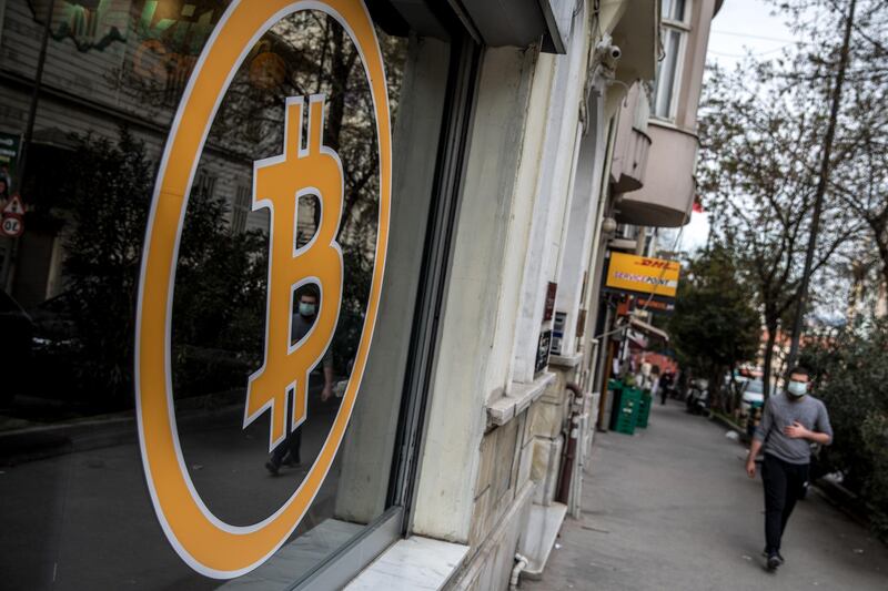 ISTANBUL, TURKEY - APRIL 16: People walk past the entrance of a cryptocurrency exchange office on April 16, 2021 in Istanbul, Turkey. Turkey's Central Bank announced a ban on the use of cryptocurrencies and crypto assets for purchases, directly or indirectly to pay for goods or services. The announcement comes as Turkey's crypto market has boomed over the past few years. As the Turkish Lira has slumped, many people have looked to cryptocurrencies to shelter against inflation. Cryptocurrencies gained traction globally this week after cryptocurrency exchange Coinbase launched on the New York Stock Exchange. (Photo by Chris McGrath/Getty Images)