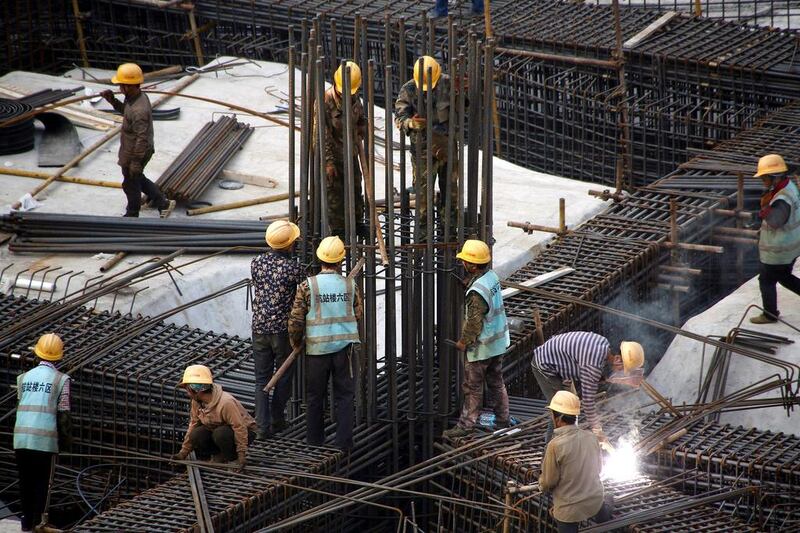 Workers labour at the construction site of the terminal for the Beijing New Airport in Beijing's southern Daxing District, China October 10, 2016. REUTERS/Thomas Peter