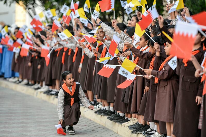 Schoolchildren welcome the Pope to Bahrain. Khushnum Bhandari / The National