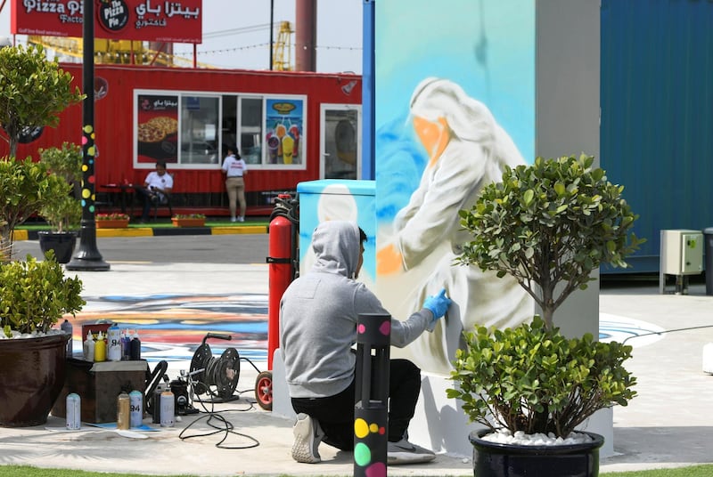 Abu Dhabi, United Arab Emirates - Graffiti artist finishes up a drawing at the grand opening of MARSA MINA, at Zayed Port. Khushnum Bhandari for The National