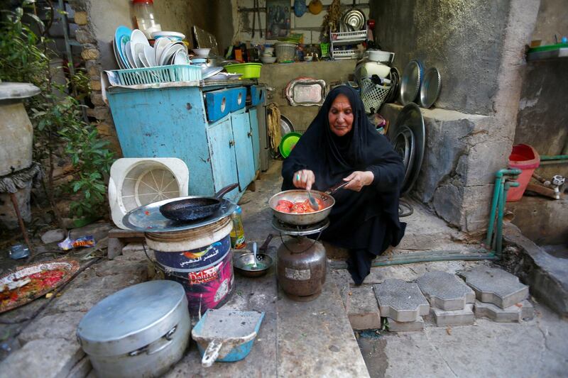 An Iraqi woman prepares Iftar (breaking fast) meals during the holy month of Ramadan, amid the spread of the coronavirus disease (COVID-19), in the holy city of Najaf, Iraq. REUTERS