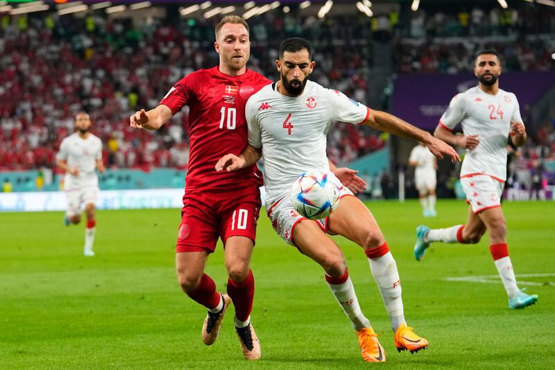 Denmark's Christian Eriksen, left, and Yassine Meriah of Tunisia during the World Cup Group D goalless draw at the Education City Stadium in Qatar, on Tuesday, November  22, 2022. AP