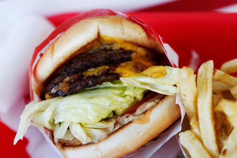 In-N-Out Burger's signature Double-Double cheeseburger and french fries are arranged for a photograph at a restaurant in Costa Mesa, California, U.S., on Wednesday, Feb. 6, 2013. In-N-Out, with almost 280 units in five states, is valued at about $1.1 billion based on the average price-to-earnings, according to the Bloomberg Billionaires Index. Photographer: Patrick T. Fallon/Bloomberg