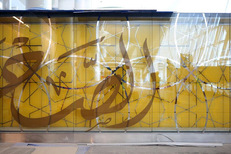 Arabic script decorates the glass wall of a boarding gate at the Midfield Terminal. Natalie Naccache / Bloomberg