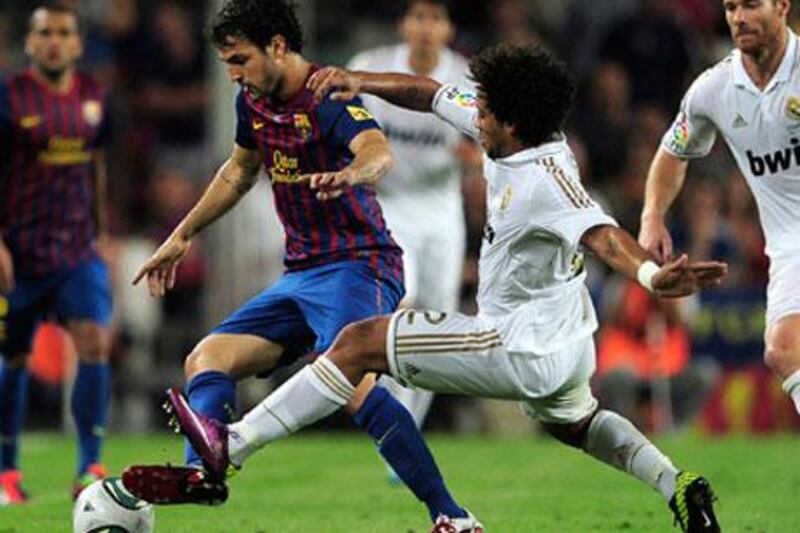 Cesc Fabregas, with the ball, and the rest of his Barcelona teammates do not want to hear about how Marcelo and his Real Madrid teammates may be the better team in La Llga.