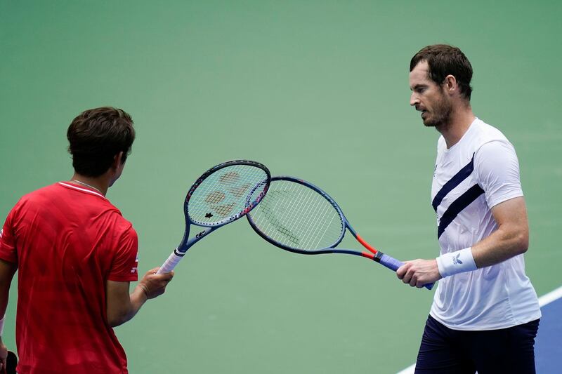 Murray taps rackets with Yoshihito Nishioka. AP