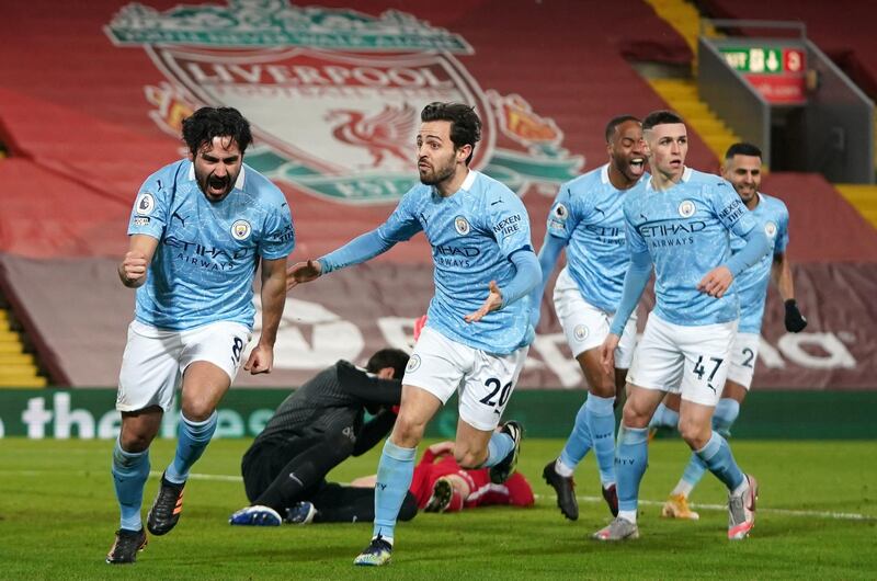 Ilkay Gundogan, left, celebrates scoring Manchester City's opening goal in their 4-1 win against Liverpool at Anfield, on February 7. PA