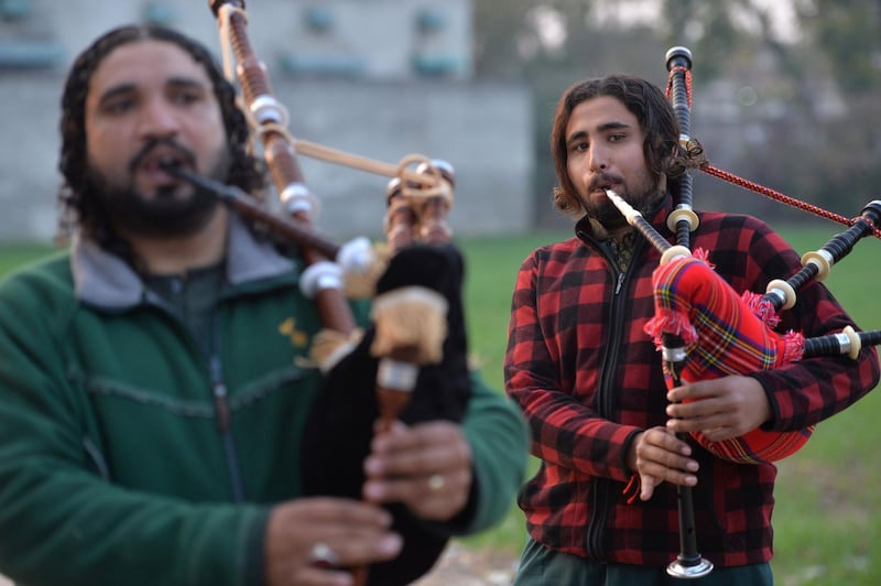 A Pakistani musical band perform with bagpipes made at the Mid East bagpipe factory in the eastern city of Sialkot. AFP.
