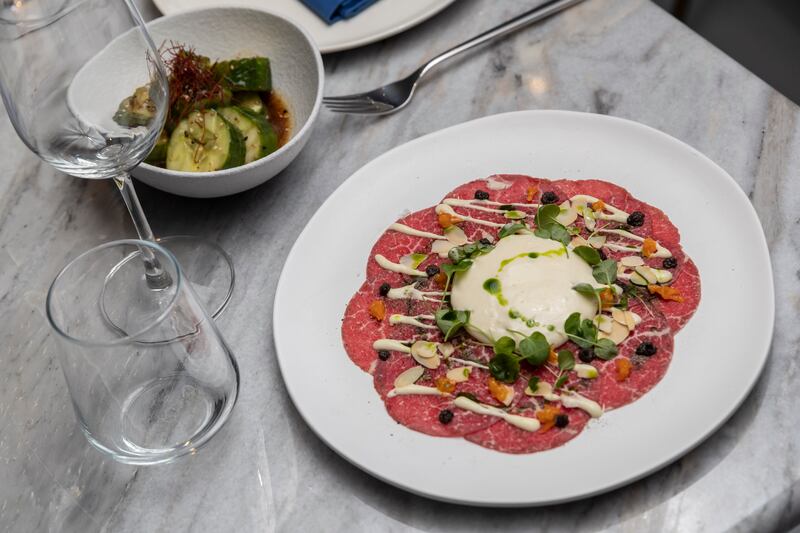 Cucumber and miso bites, left, and beef carpaccio.