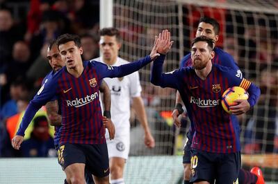 epa07339289 FC Barcelona's Argentinian striker Lionel Messi (R) celebrates with Philipe Coutinho (2-L) after scoring the 1-2 during their Spanish LaLiga Primera Division soccer match against Valencia CF played at Camp Nou stadium, in Barcelona, Spain, 02 February 2019.  EPA/Alberto Estevez