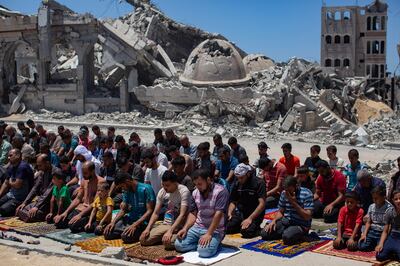 Displaced Palestinians perform Friday prayers next to the ruins of the Al Islam Mosque, which was destroyed in an Israeli air strike, in Khan Younis, southern Gaza. EPA