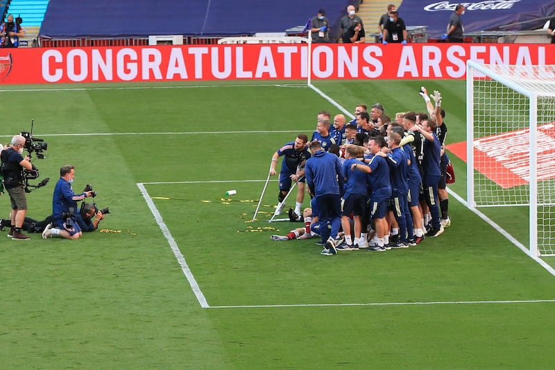 Arsenal players pose after the FA Cup final. AP