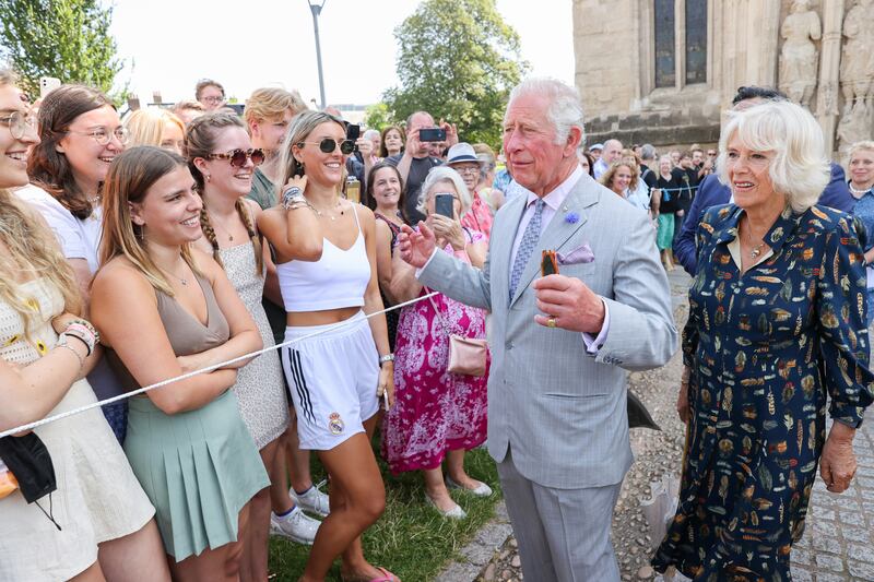 Prince Charles and Camilla meet a group of young people during a visit to Exeter Cathedral.