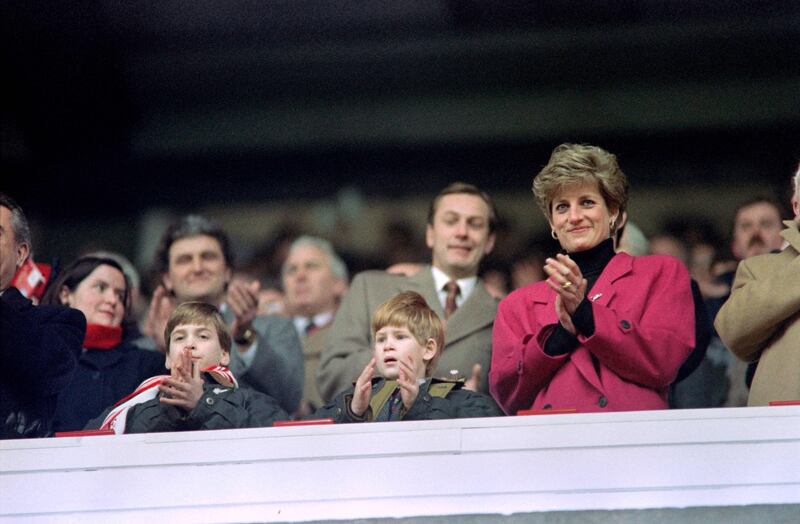 Princes William and Harry applaud alongside their mother, Princess Diana, during a Five Nations rugby match between Wales and France in 1992. AFP