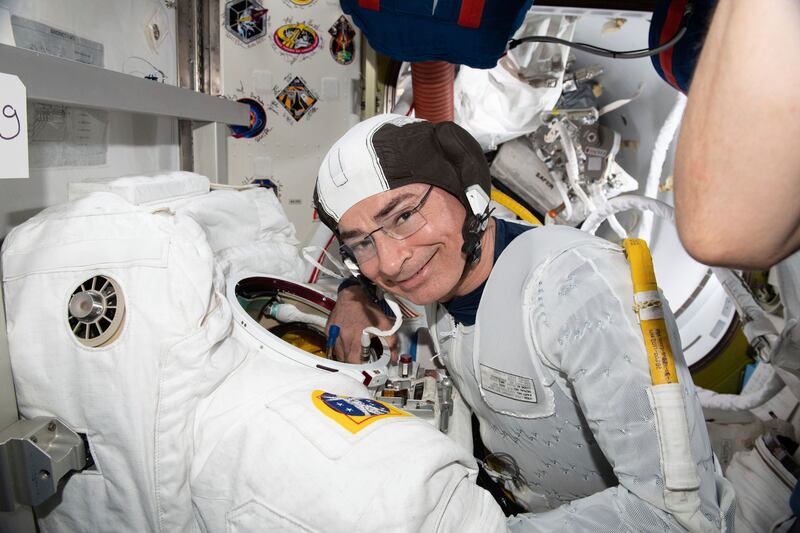 Astronaut and Expedition 65 Flight Engineer Mark Vande Hei inspects a spacesuit in preparation for a spacewalk at the International Space Station on April 17, 2021. AP