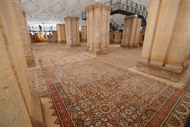 A general view shows a large mosaic after restoration at Hisham's Palace, an early Islamic archaeological site, in the West Bank city of Jericho, 28 October 2021.  The mosaic floor dating back to the Umayyad era contains 38 carpet-like connected panels covering ca.  827 square meters.  The multi-year restoration project, done in cooperation between the Palestinian Ministry of Tourism and Antiquities and the Japanese International Cooperation Agency (JICA) at a cost of 12 million USD, includes the construction of a protective roof and exhibition facilities.  
Hisham's Palace, built in the first half of the 8th century AD, is attributed to the Umayyad Caliph Hisham ibn Abd al-Malik.  The mosaic was previously buried with sand and insulating materials for many years to protect it from climatic influences.   EPA / ATEF SAFADI