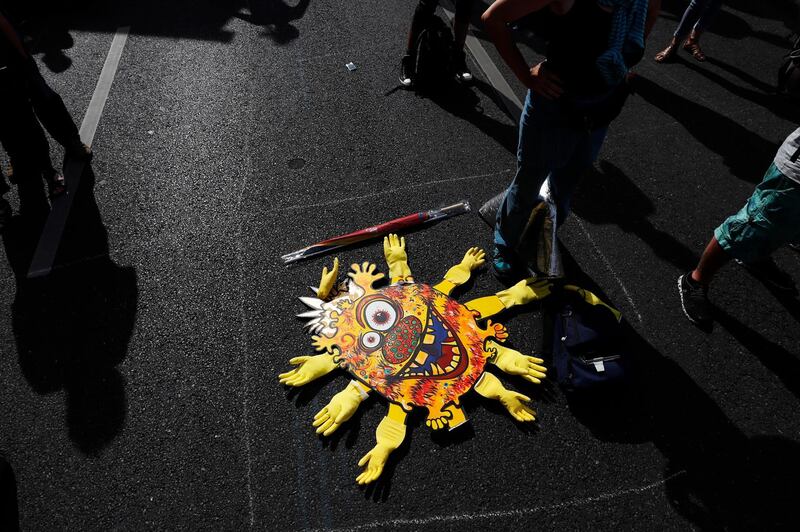 Participants stand next to a stylised virus symbol during a protest against coronavirus pandemic regulations in Berlin, Germany.  EPA