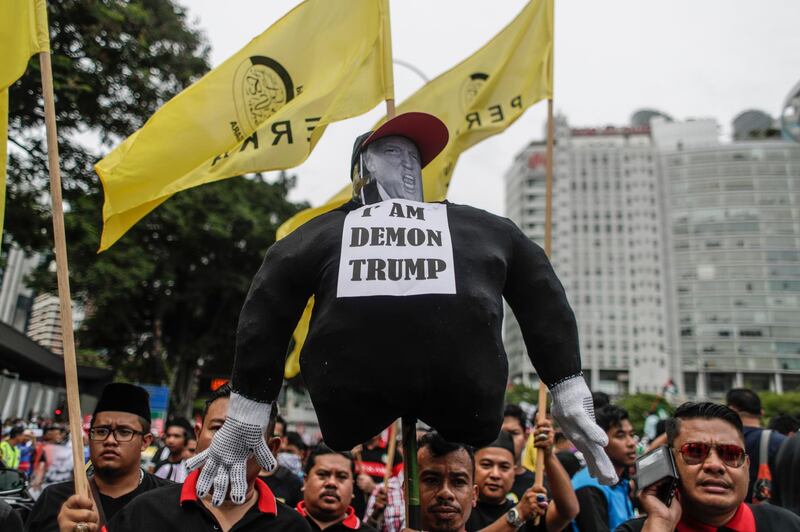 Protesters hold an effigy of Donald Trump during a rally against the US president's recognition of Jerusalem as Israel's capital, in front of the US embassy in Kuala Lumpur, Malaysia on December 8, 2017. Fazry Ismail / EPA