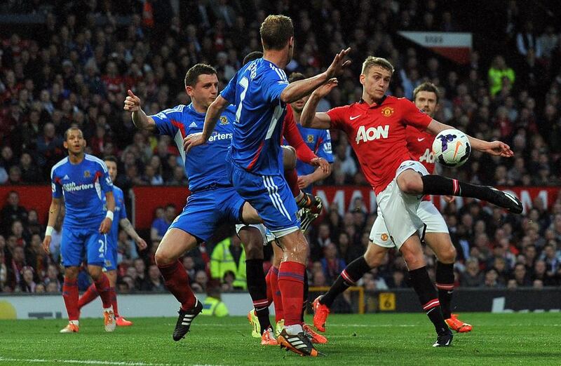 Manchester United striker James Wilson shoots to score the opening goal against Hull City at Old Trafford on Tuesday. Paul Ellis / AFP / May 6, 2014