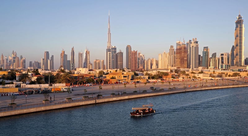 A picture taken on April 4, 2017, shows Dubai's skyline dominating the water canal, which links the city's business hub to the Gulf. (Photo by KARIM SAHIB / AFP)