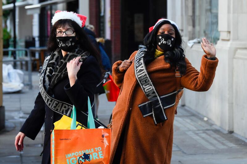 Shoppers wear face masks and Christmas hats in Regent Street. AP Photo
