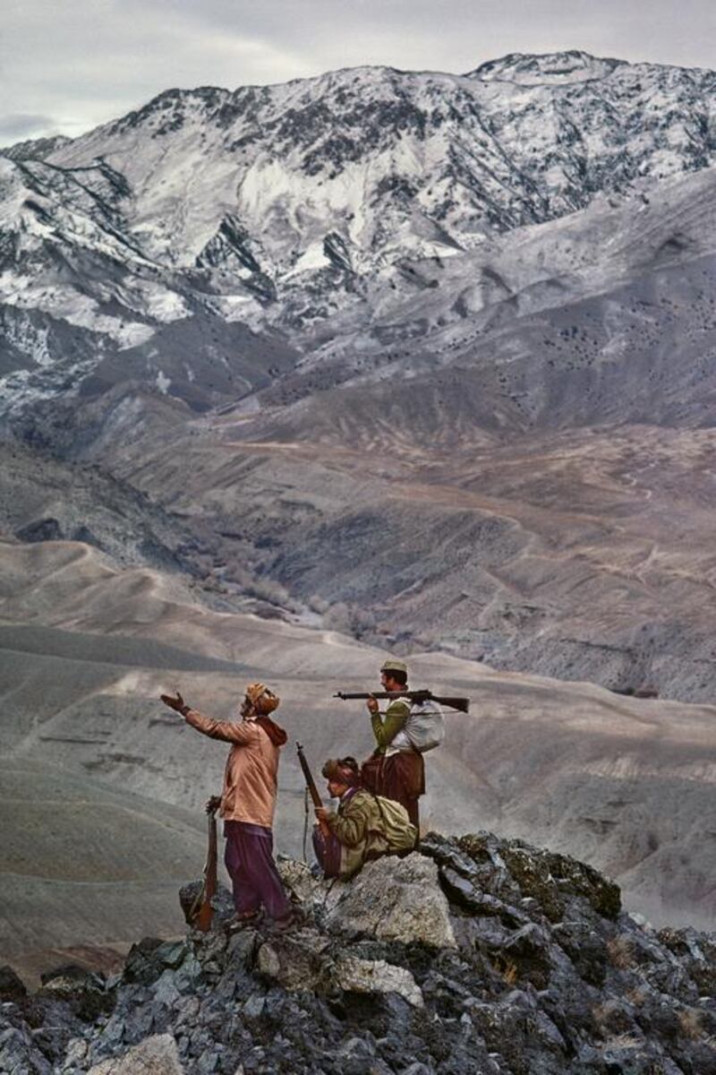 Mujahideen stand atop a mountain in the Hindu Kush, 1984. Copyright ©Steve McCurry / Magnum Photos