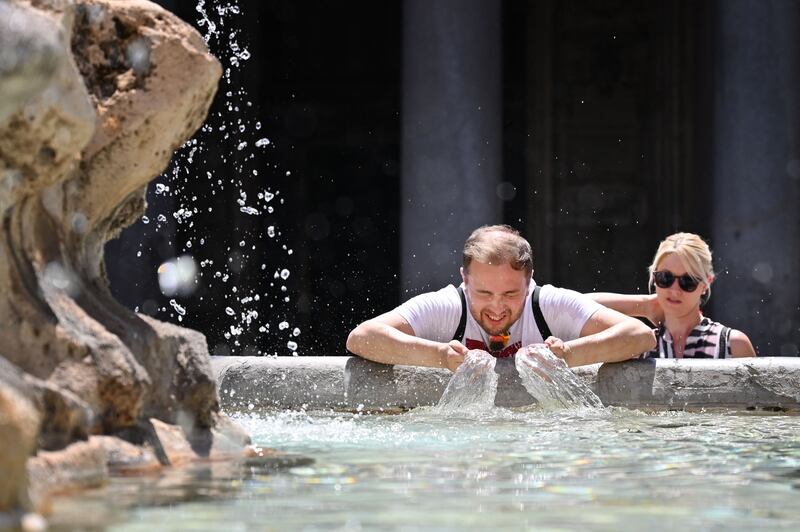 A man cools off in a fountain at Piazza della Rotonda in Rome in a heatwave that has also devastated parts of Greece, Turkey and Algeria, where deaths and evacuations have been commonplace over the past few days. AFP