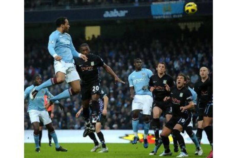 Joleon Lescott heads home for Manchester City against Aston Villa. The defender is confident his team can fight for the title.