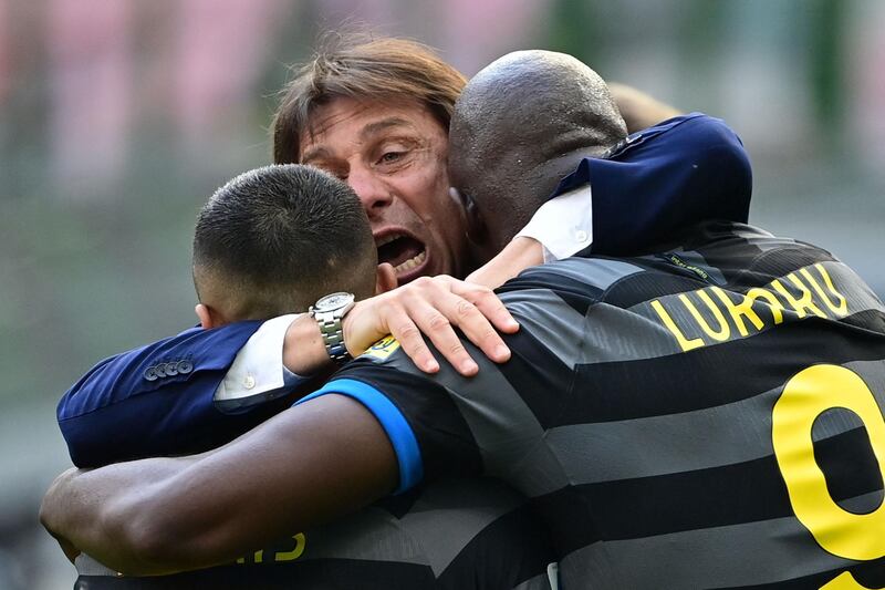 Antonio Conte hugs Inter Milan forwards Alexis Sanchez and Romelu Lukaku. AFP